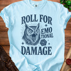 Light blue t-shirt with dark blue graphic of an owl, dice, and text reading "Roll for Emotional Damage".