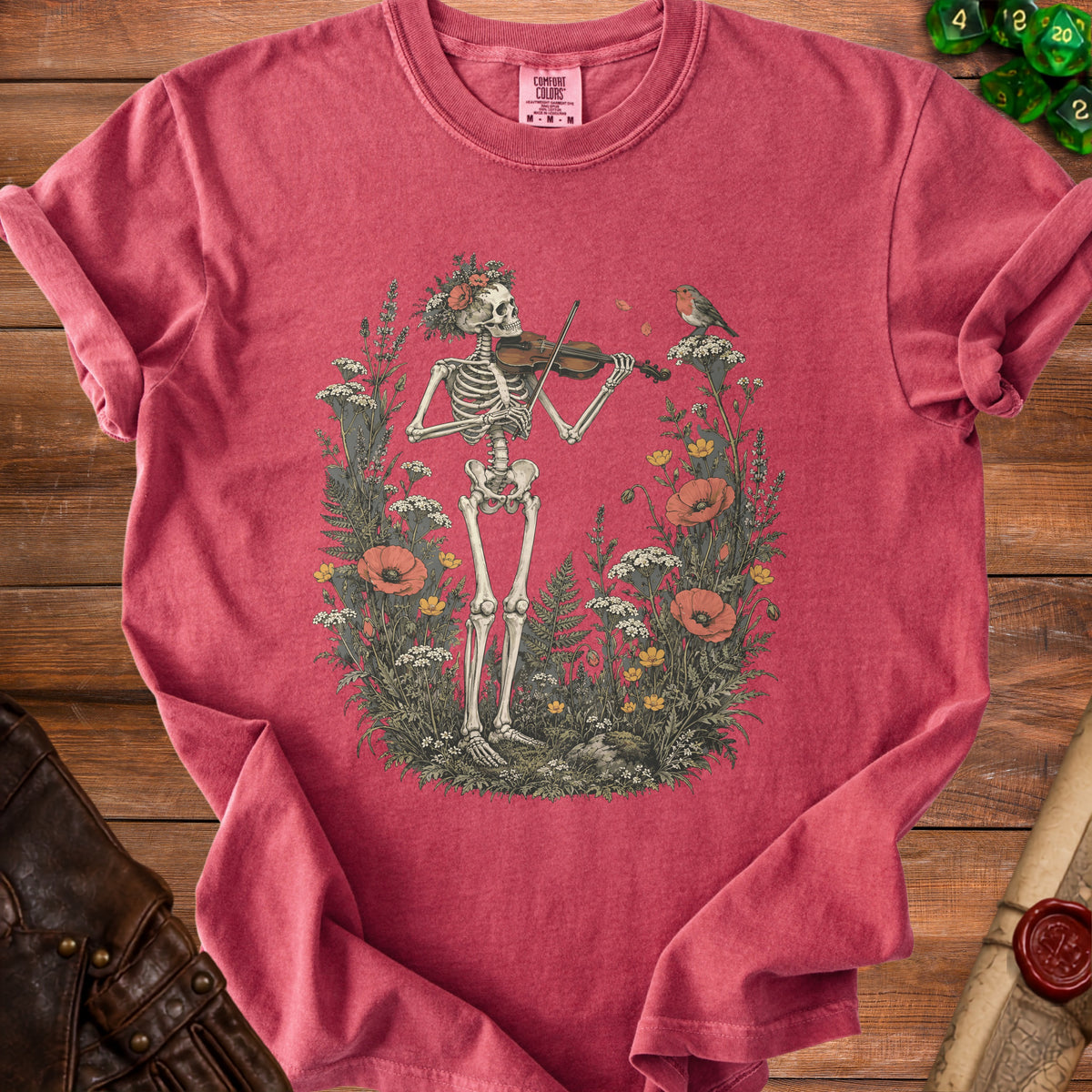 Skeleton playing violin in a garden with a bird, on a pink t-shirt.