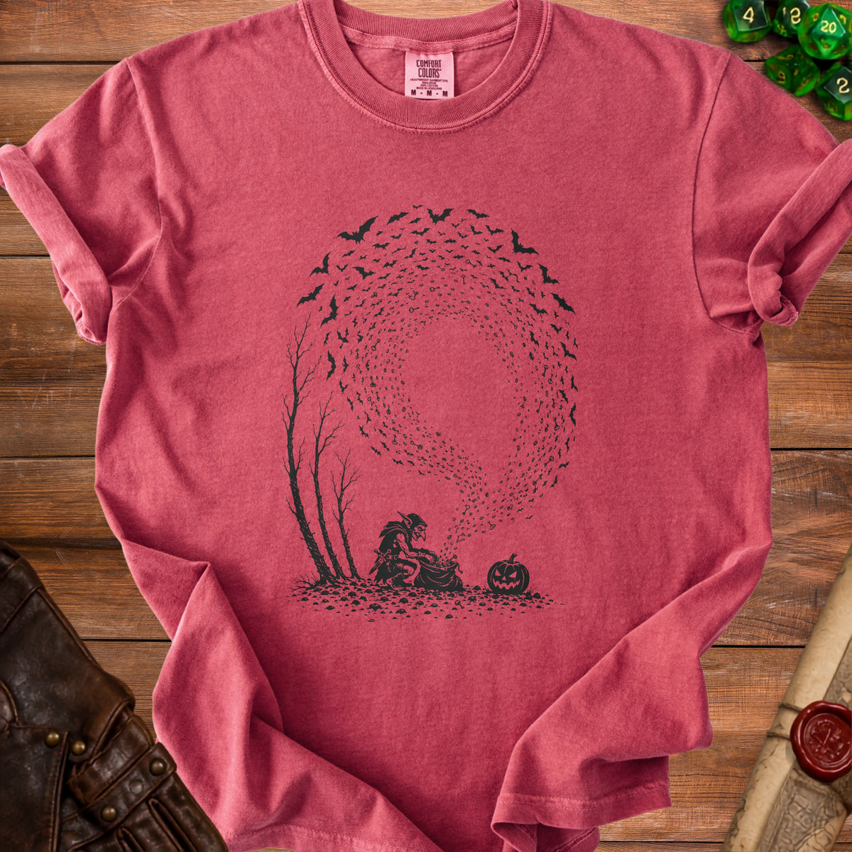Red t-shirt with a black graphic of a goblin, pumpkin, and bats flying from keys.