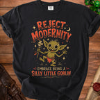 Black t-shirt with a goblin graphic and text "REJECT MODERNITY EMBRACE BEING A SILLY LITTLE GOBLIN".