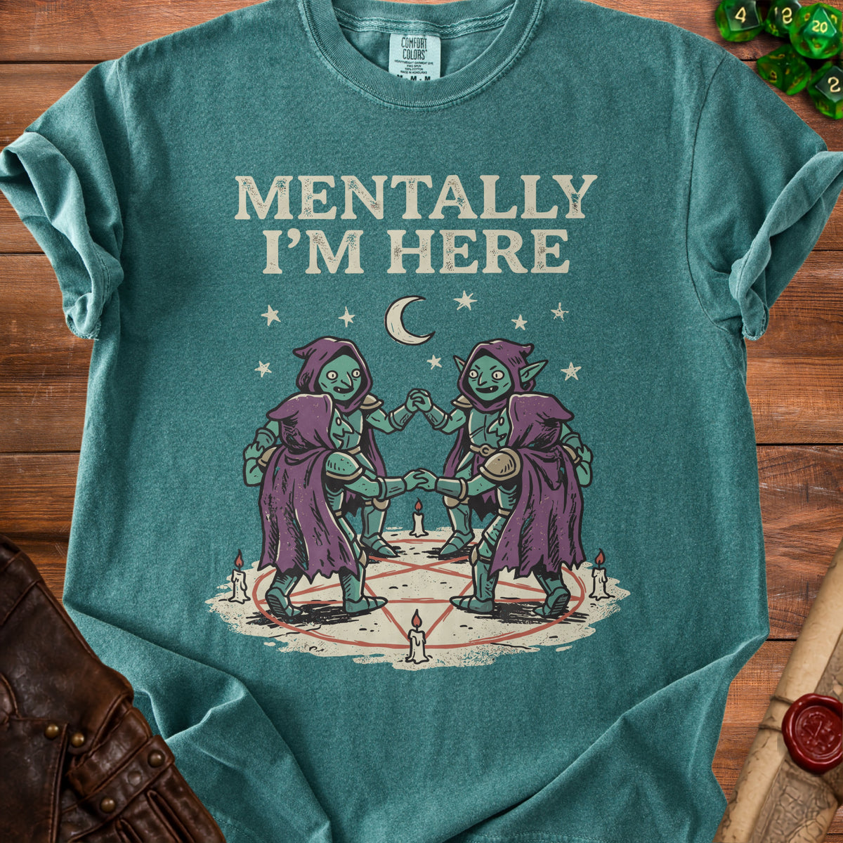Green t-shirt with text "MENTALLY I'M HERE" above goblins in a circle.