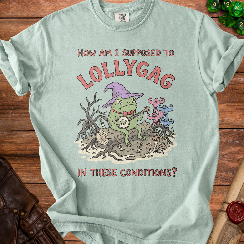 Light green t-shirt with frog wizard playing banjo and text "How am I supposed to Lollygag in these conditions?".