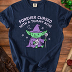 Navy t-shirt with a goblin character and text "FOREVER CURSED WITH A TUMMY ACHE".
