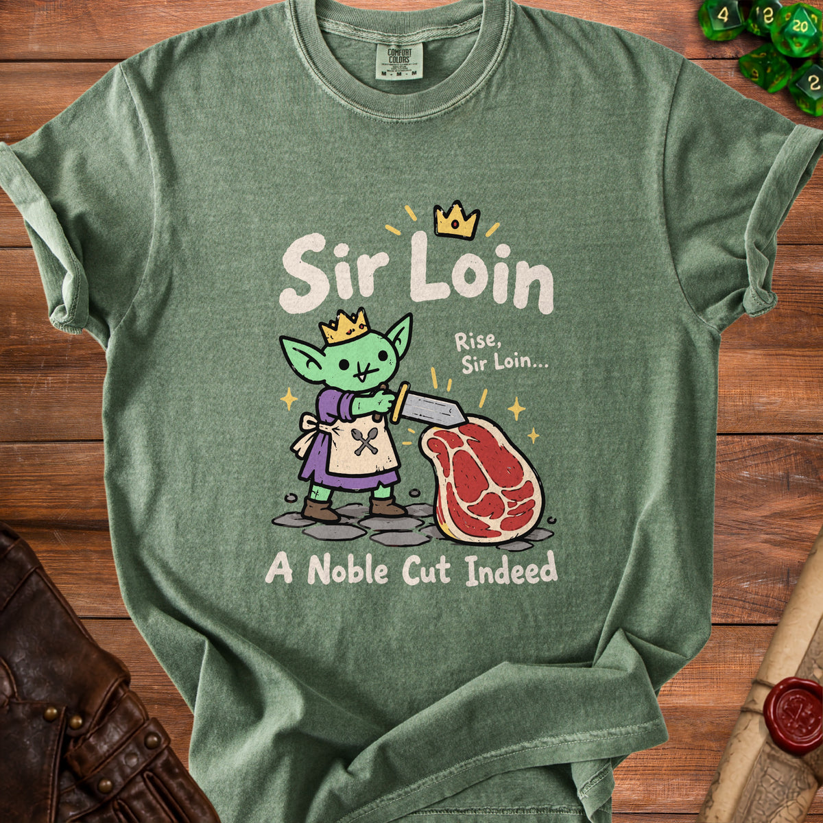 Green t-shirt with a goblin character holding a sword over a steak, reading "Sir Loin A Noble Cut Indeed".