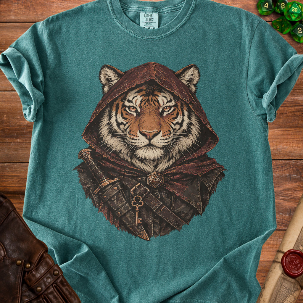 Teal t-shirt featuring a graphic of a tiger wearing a hooded cloak, dagger, and keys.