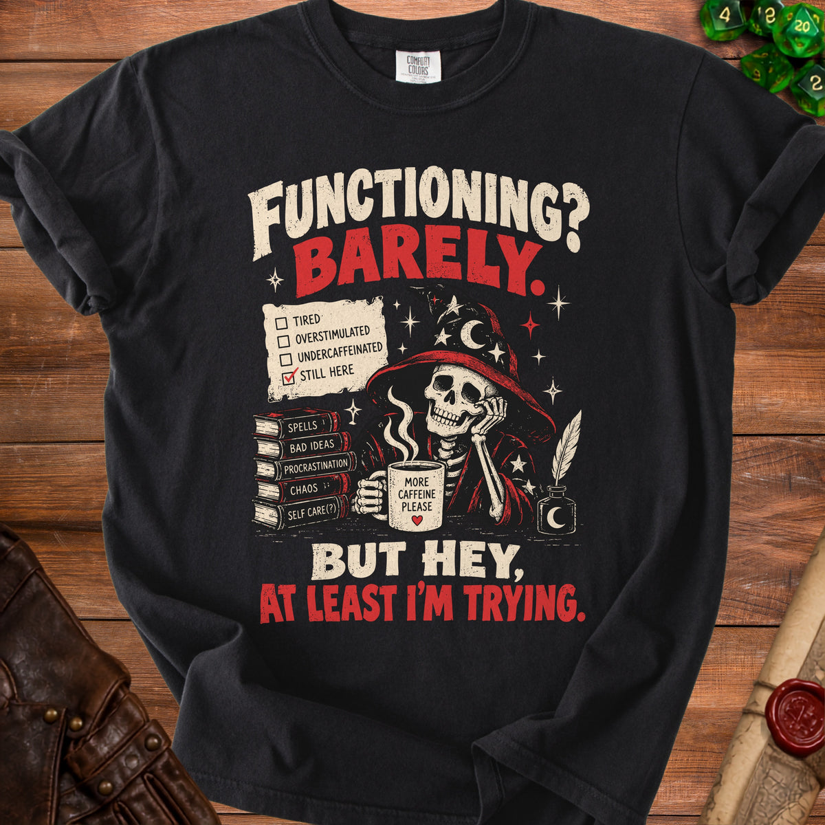 Black t-shirt with skeleton wearing wizard hat and text "Functioning? Barely. Still here. More Caffeine Please. But Hey, At Least I'm Trying."