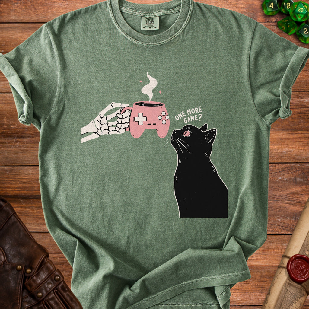 Skeleton hand holding a video game controller mug with steam, next to a black cat.