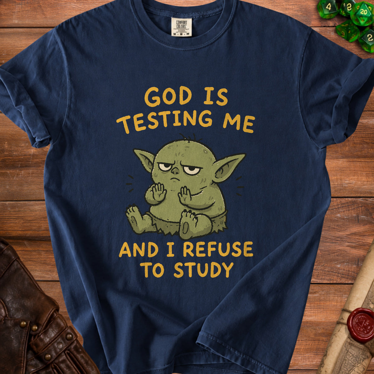Navy t-shirt with cartoon Yoda saying "God is testing me and I refuse to study".