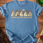 Blue t-shirt with ghosts in wizard hats performing "normal wizard activities".