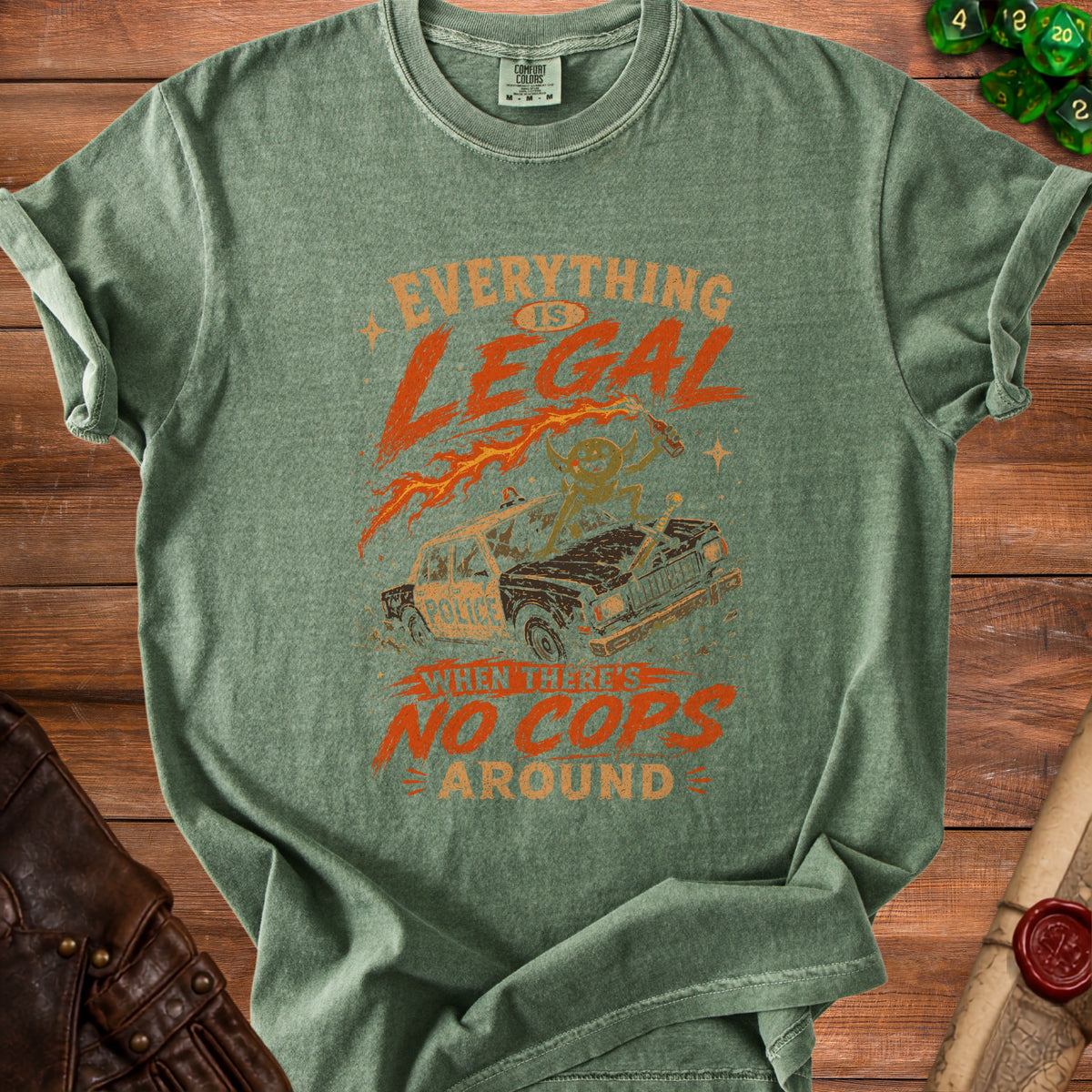 Green t-shirt with text "Everything Is Legal When There's No Cops Around" and graphic.