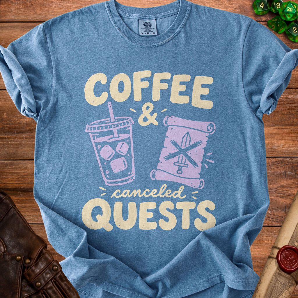 Blue t-shirt with "Coffee & Canceled Quests" graphic featuring a drink and scroll.