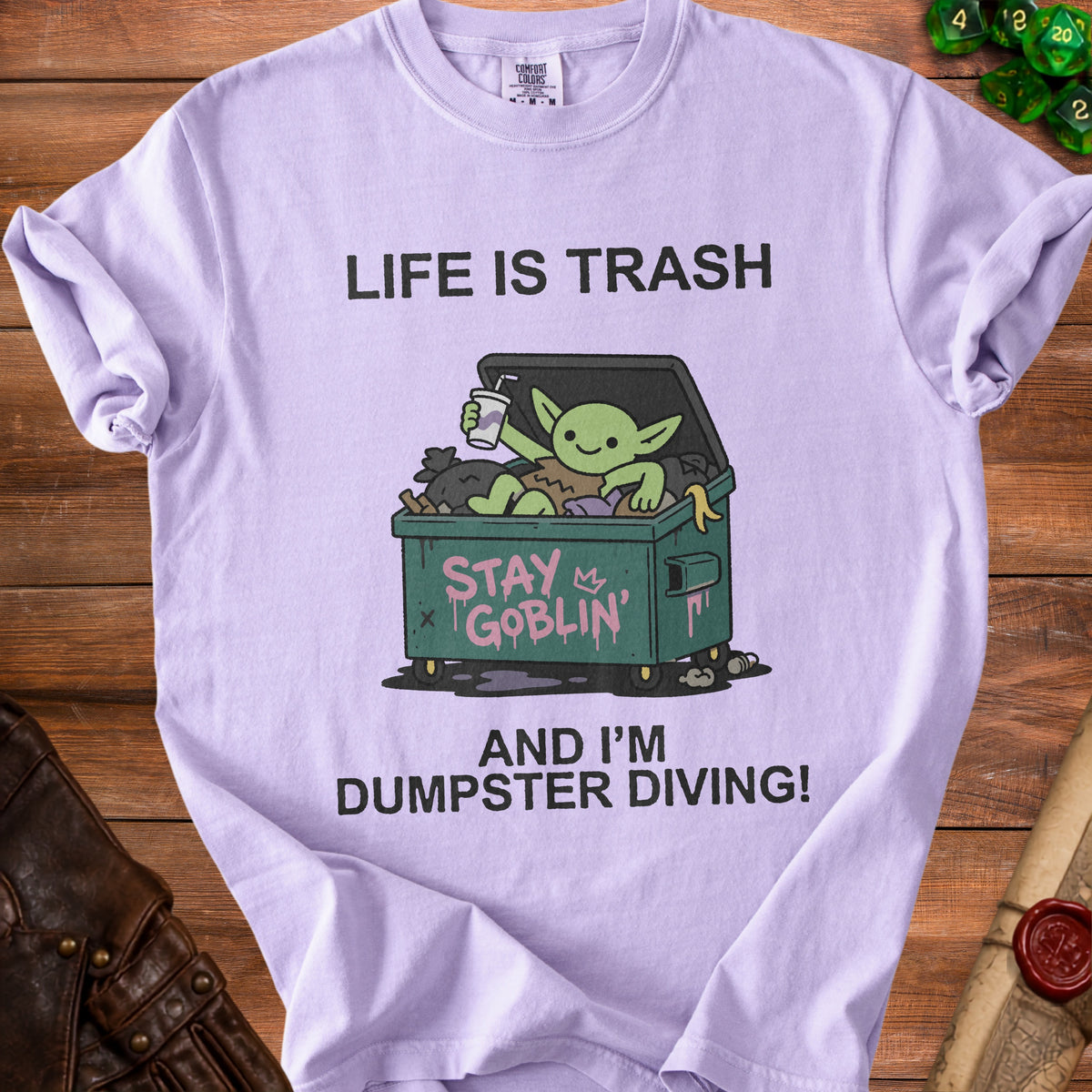 Lilac t-shirt with "Life is Trash, Stay Goblin, and I'm Dumpster Diving!" graphic.