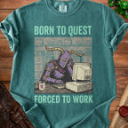Green t-shirt with text "BORN TO QUEST FORCED TO WORK" and knight at a computer.
