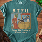 T-shirt with medieval-style illustration of a cat holding a fish and the text "S.T.F.U. Sorry, The Familiar's Unsupervised."