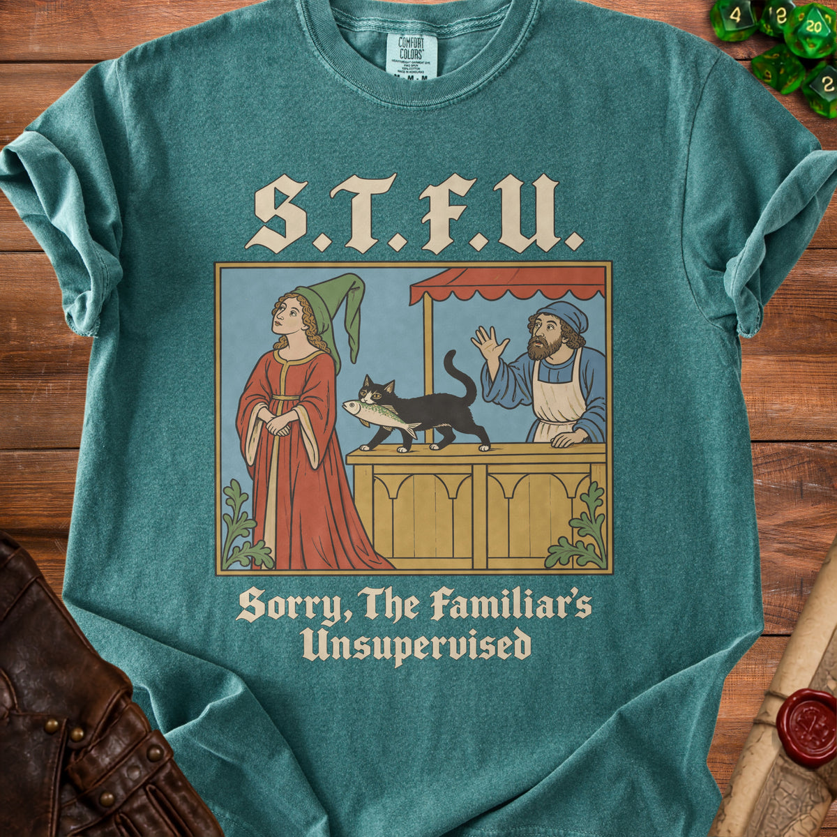T-shirt with medieval-style illustration of a cat holding a fish and the text "S.T.F.U. Sorry, The Familiar's Unsupervised."