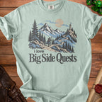 T-shirt with "i love Big Side Quests" text and a mountain landscape graphic.