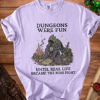 Purple t-shirt with "Dungeons Were Fun Until Real Life Became The Boss Fight." graphic.