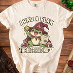 Beige t-shirt featuring a cartoon frog wizard holding a critical fail die and map, with text reading I had a plan the dice had other notes.