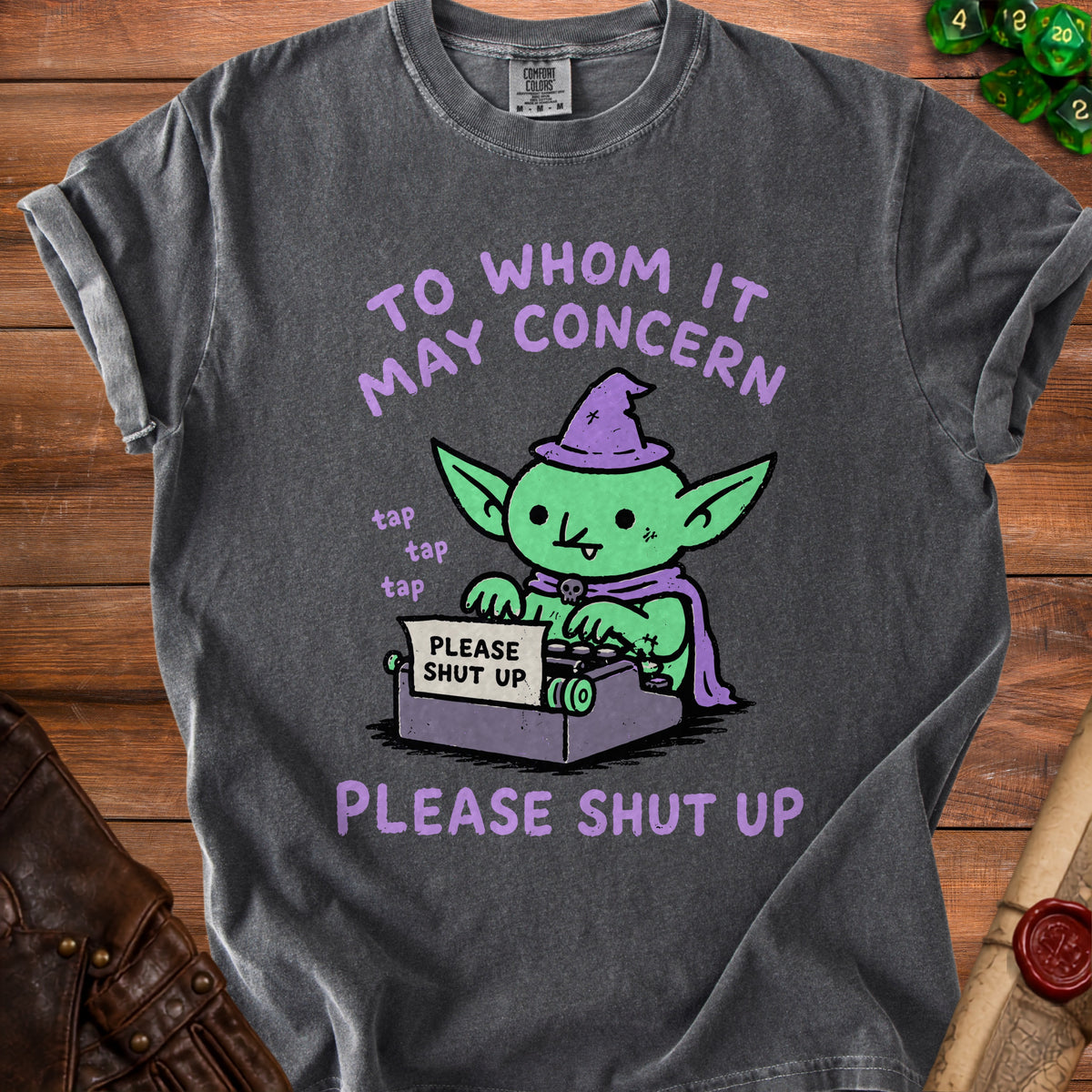 Green goblin with witch hat typing "PLEASE SHUT UP" on typewriter.