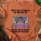 Orange t-shirt graphic: knight in bed, "How it feels to wake up on your day off and not have to log into Teams or Outlook."