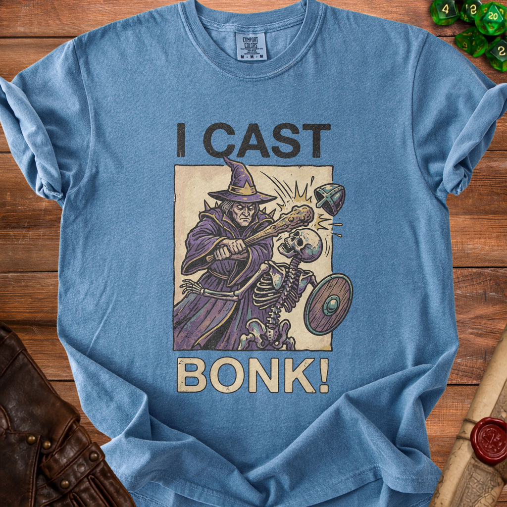 Blue t-shirt with wizard casting "BONK!" on a skeleton, "I CAST" text.
