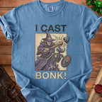 Blue t-shirt with wizard casting "BONK!" on a skeleton, "I CAST" text.