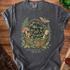 T-shirt with a basket, d20 die, mushrooms, ferns, and scroll graphic. "Foraging For Loot" text.