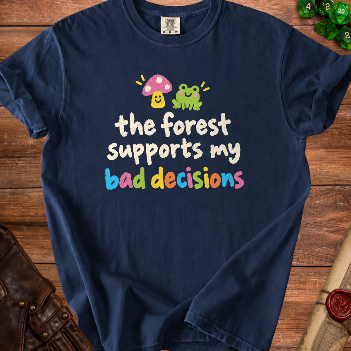 Navy t-shirt with text "the forest supports my bad decisions" and cartoon mushroom and frog.