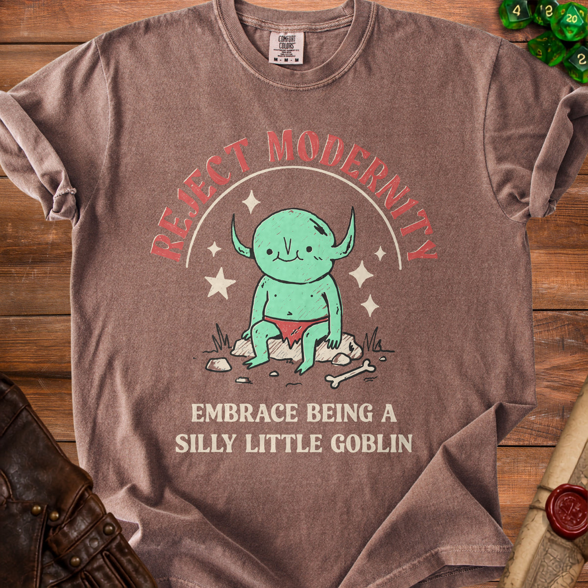 Brown t-shirt with "Reject Modernity Embrace Being A Silly Little Goblin" and goblin graphic.