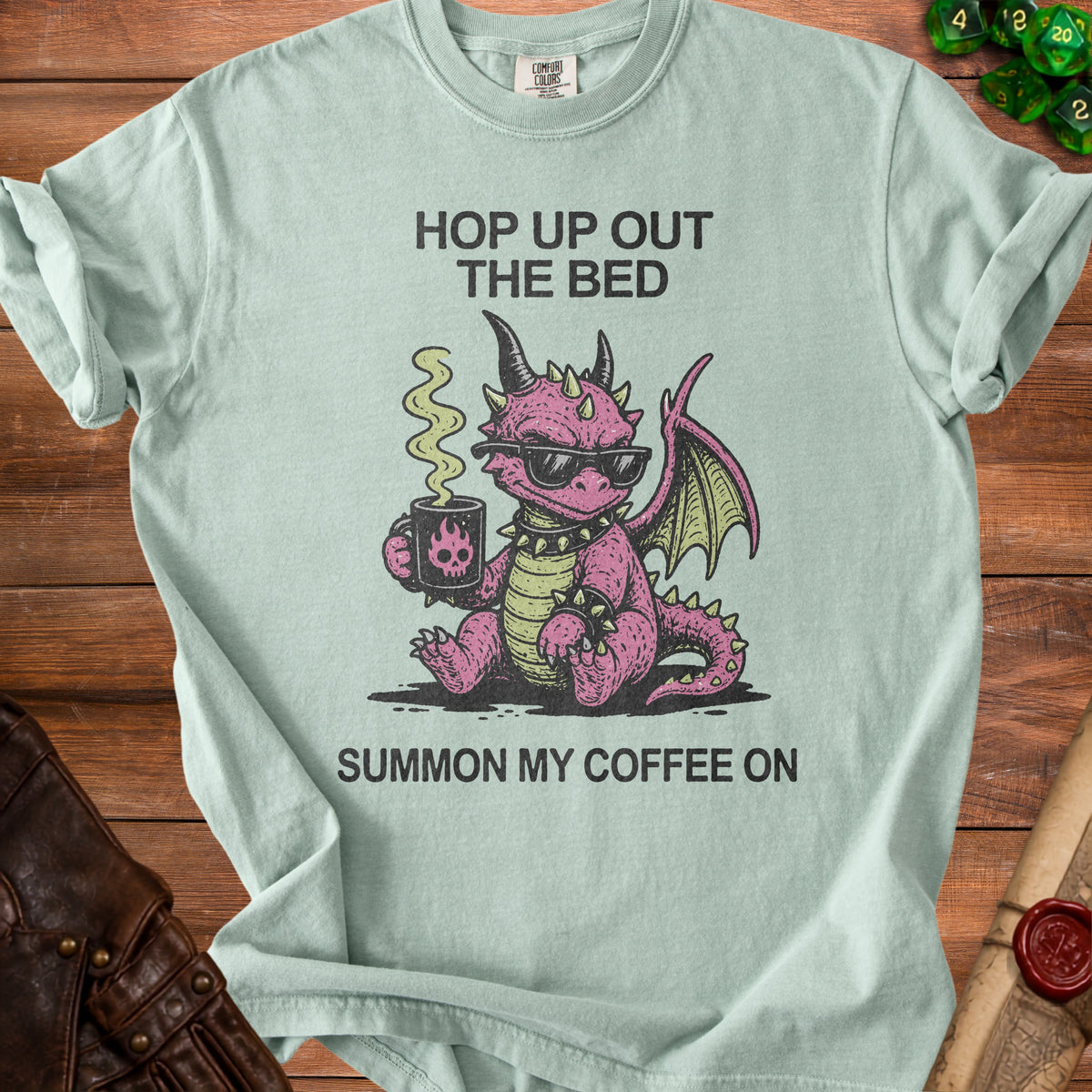 Light blue t-shirt with pink dragon holding coffee and text "Hop Up Out The Bed Summon My Coffee On".