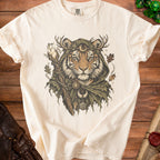 Cream t-shirt featuring a mystical tiger wearing antlers, a crescent moon, and holding a crystal staff.