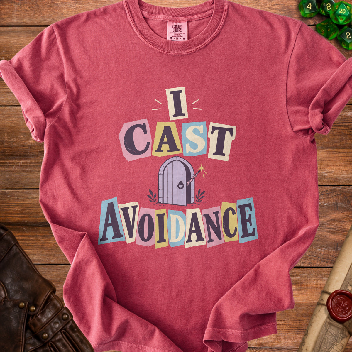 Red t-shirt with "I CAST AVOIDANCE" text and a fairy door graphic.