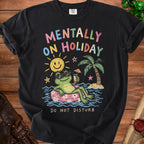 Black t-shirt with a graphic of a frog on an inner tube saying "Mentally On Holiday".