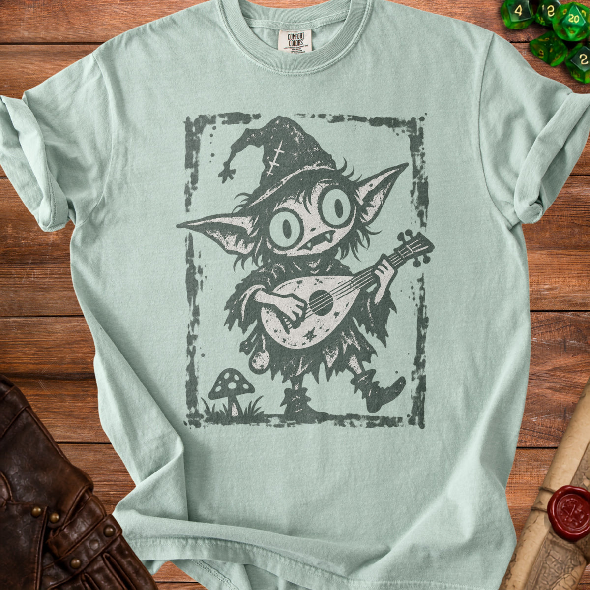 T-shirt with a distressed graphic of a goblin playing a lute and wearing a witch hat.