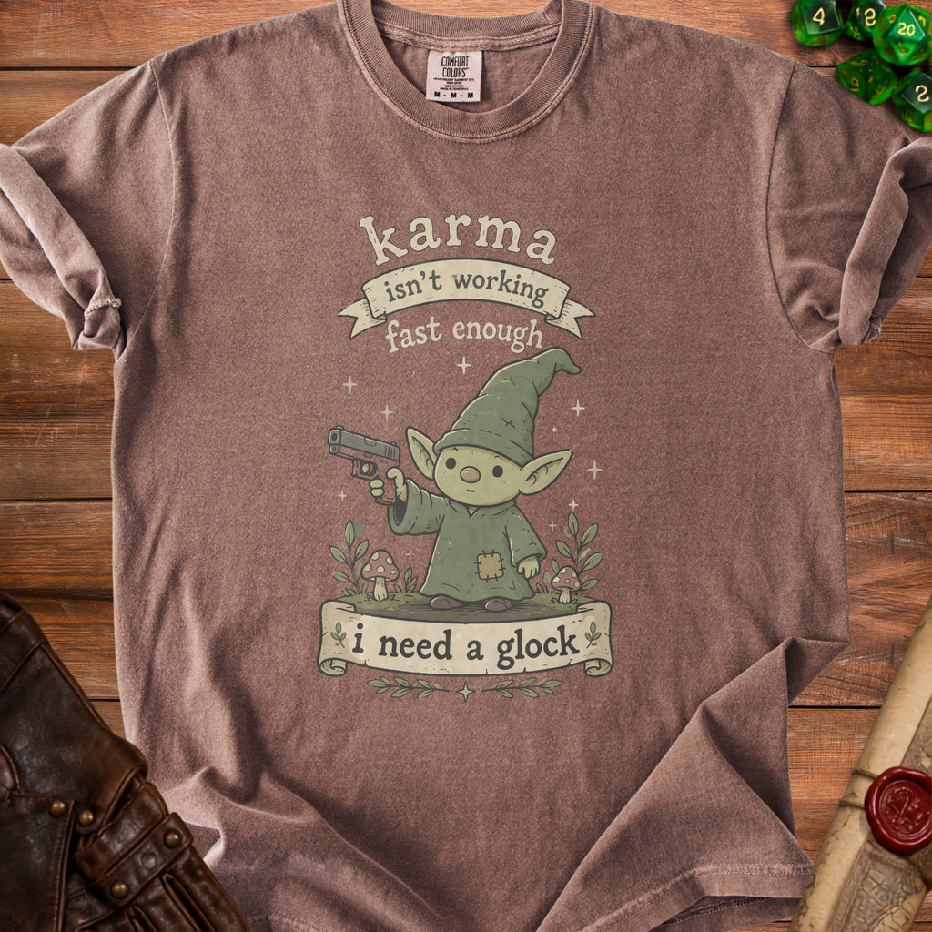 Brown t-shirt with a gnome holding a gun and text "karma isn't working fast enough i need a glock".