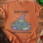 Orange t-shirt with "NOT LAZY ENERGY IS IN HUDDLE MODE" and wizard character.