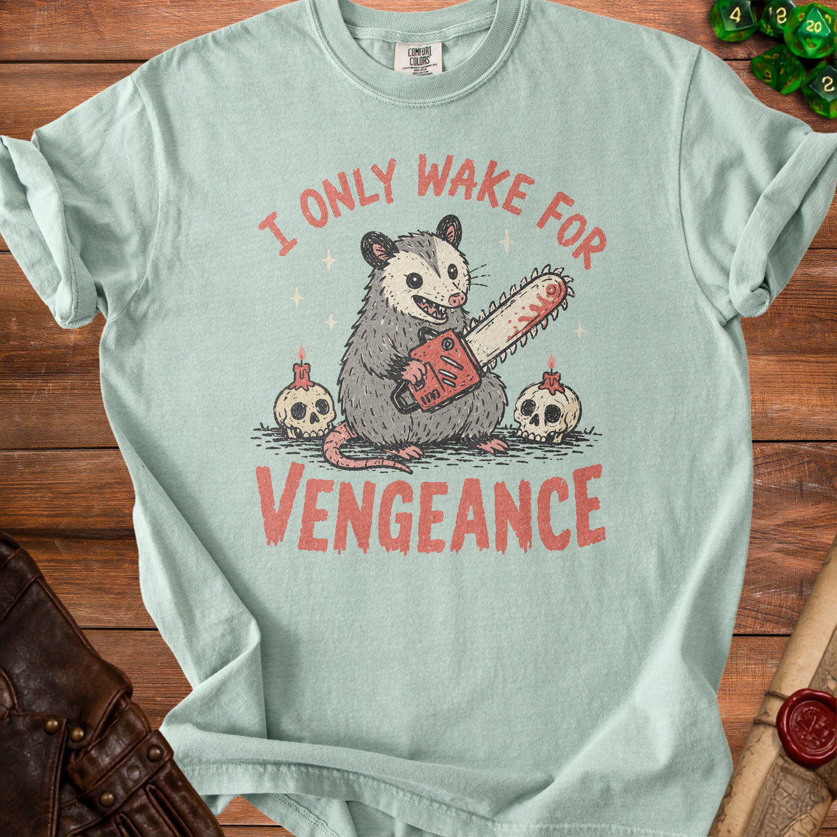 Opossum holding a chainsaw with skulls and candles, text reads "I ONLY WAKE FOR VENGEANCE".