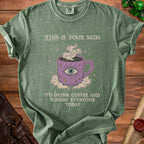 Green t-shirt with mystical coffee mug and text: "This is your sign to drink coffee and ignore everyone today."