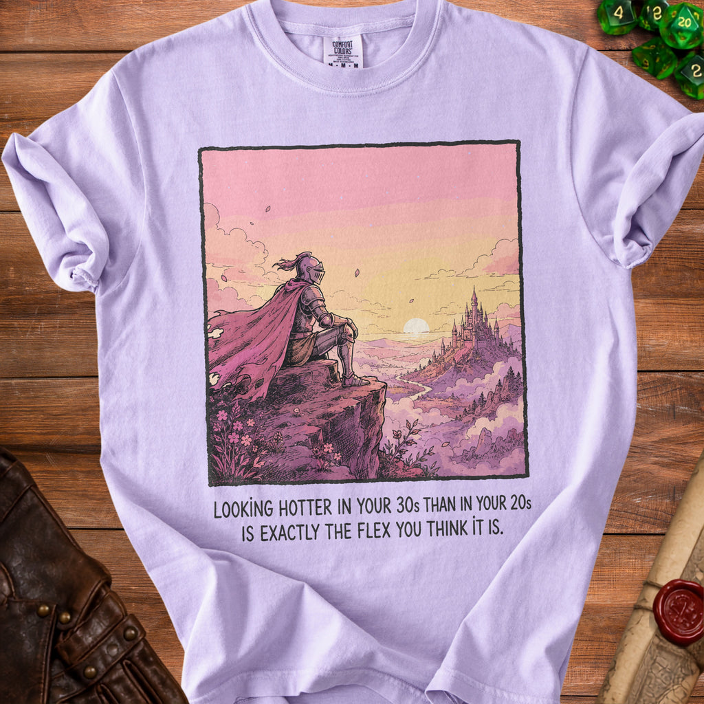 Purple t-shirt with knight on cliff overlooking castle at sunset and text.