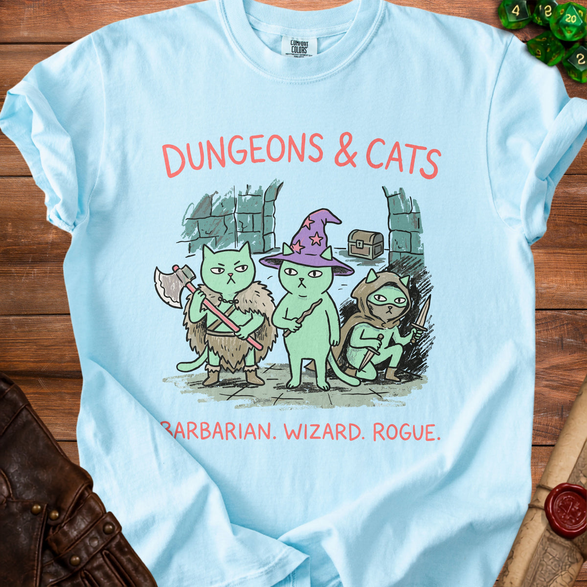 Light blue t-shirt with "Dungeons & Cats" text and barbarian, wizard, rogue cats.
