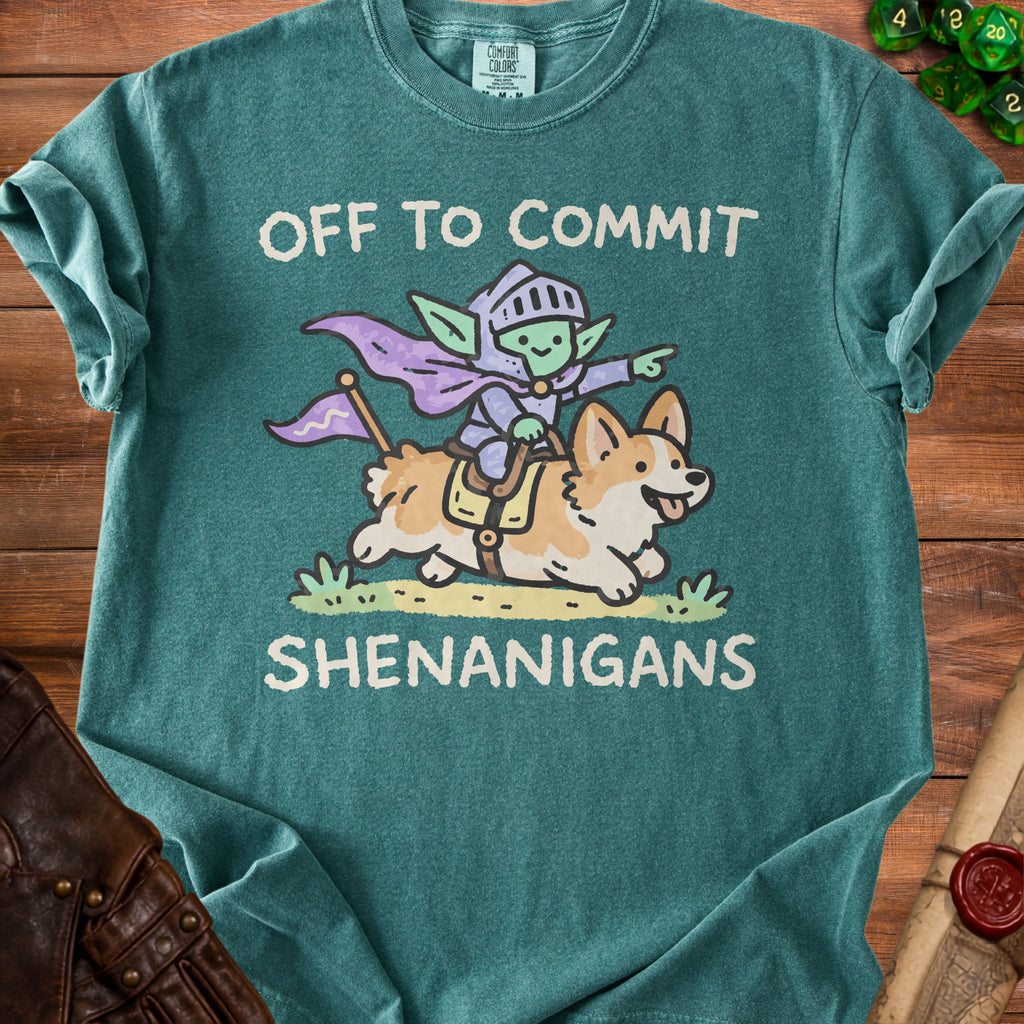 Teal t-shirt with graphic of knight goblin riding corgi, "OFF TO COMMIT SHENANIGANS".
