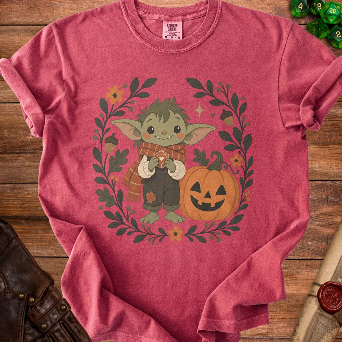 Cute alien character holding a heart dice with pumpkin and floral wreath.