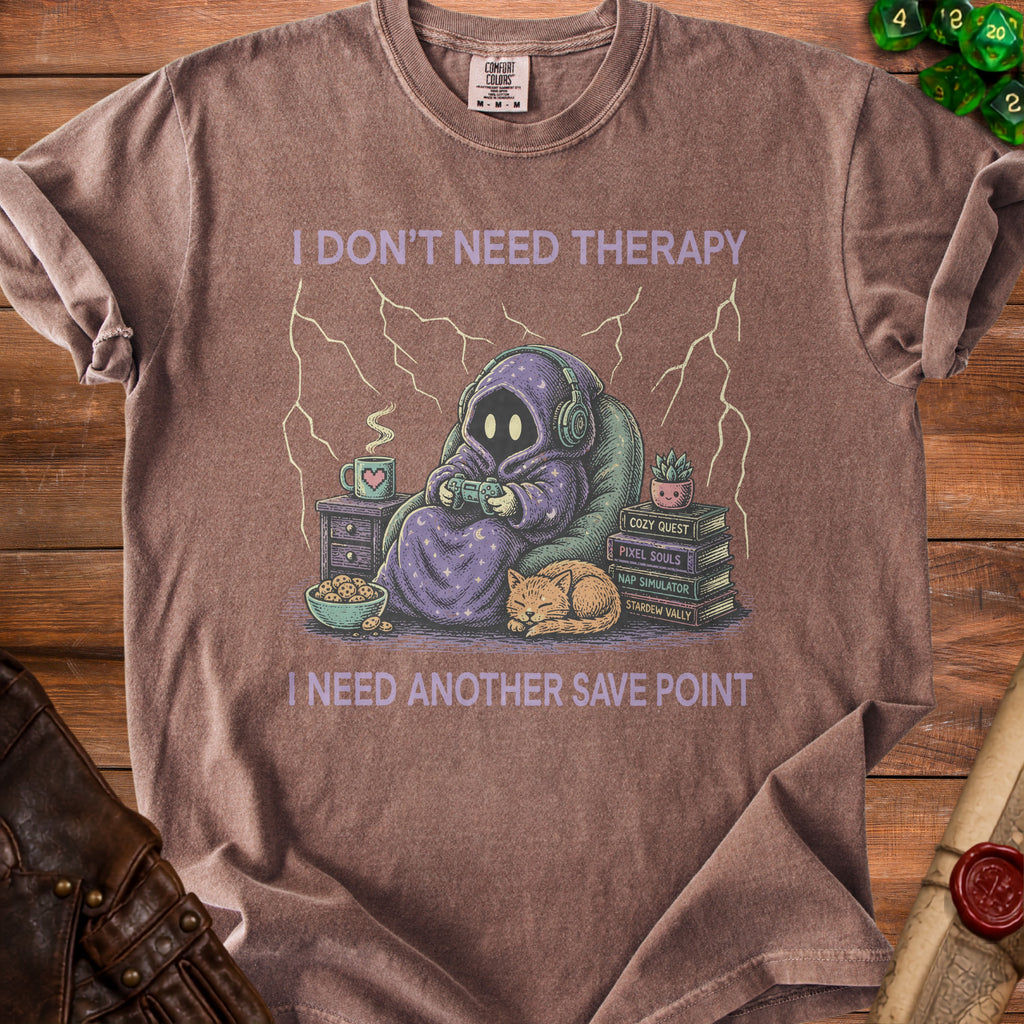 Brown t-shirt with graphic of hooded figure playing video games, text "I don't need therapy I need another save point".
