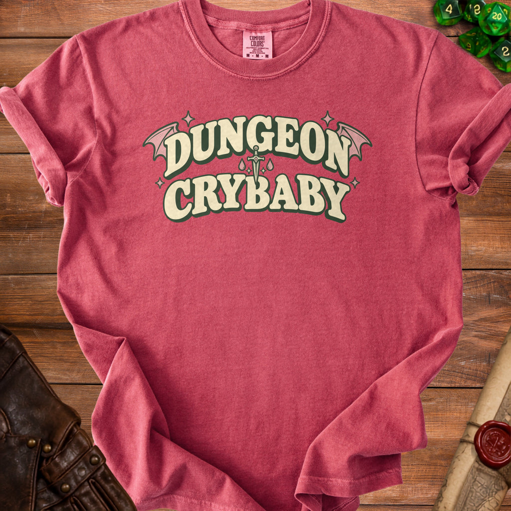 Red t-shirt with "Dungeon Crybaby" text, wings, sword, and tears design.