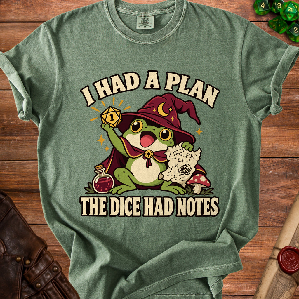 Green t-shirt featuring a frog wizard holding a critical fail die, a map, and the text I HAD A PLAN THE DICE HAD NOTES.