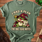 Green t-shirt featuring a frog wizard holding a critical fail die, a map, and the text I HAD A PLAN THE DICE HAD NOTES.