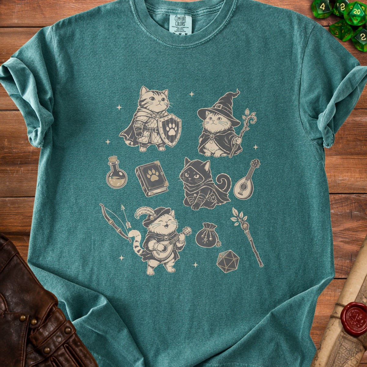 Green t-shirt with medieval fantasy cats, dice, and adventurer gear graphic.
