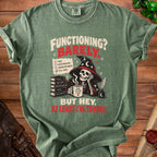 Green t-shirt with skeleton wizard graphic and text "Functioning? Barely. But hey, at least I'm trying."