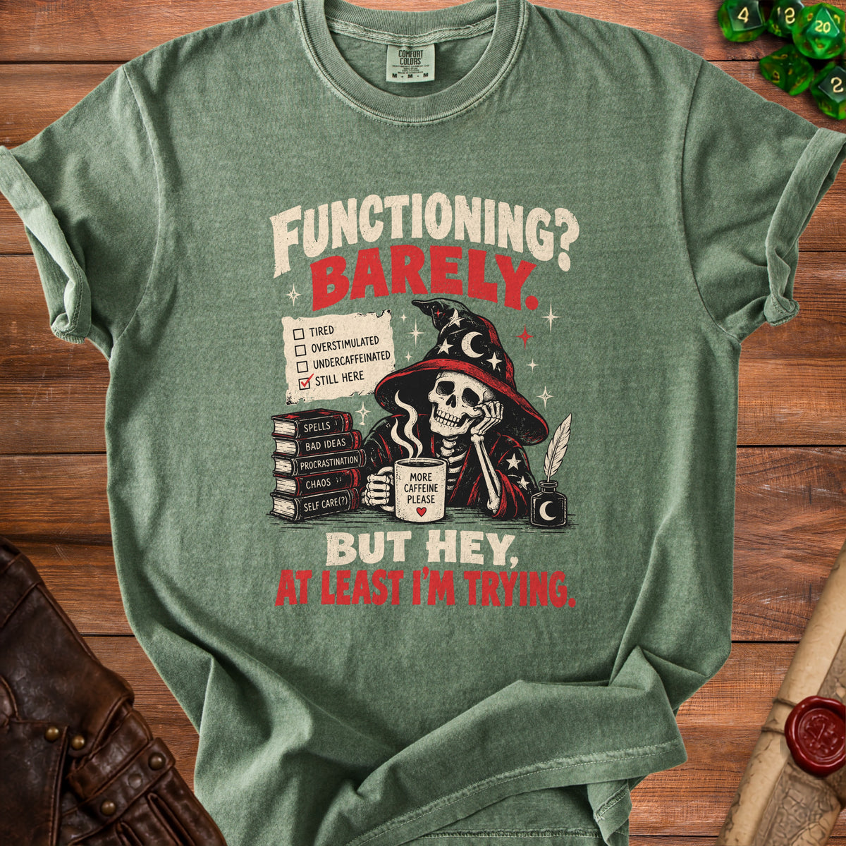 Green t-shirt with skeleton wizard graphic and text "Functioning? Barely. But hey, at least I'm trying."
