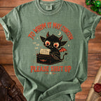 Green t-shirt with black demon typing on a vintage typewriter, reading "To Whom It May Concern Please Shut Up."